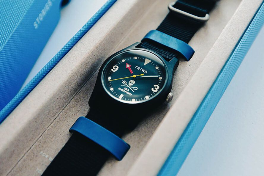 A black watch in a white and blue case.