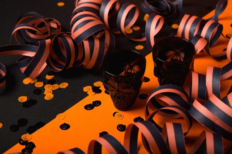 Skull-shaped glass cups with black and orange ribbon