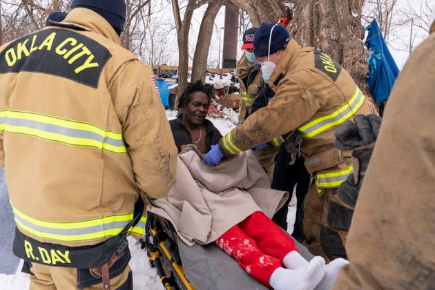 Paramedics in Oklahoma City treat Eugene Rich for frostbite amid record-breaking cold and snow on Feb.