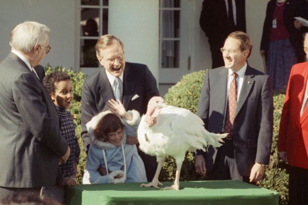 President George H.W. Bush and Shannon Duffy, 8, of Fairfax, Virginia, with a turkey at the National...